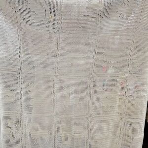 Ecru hand crocheted with animals possibly crib spread